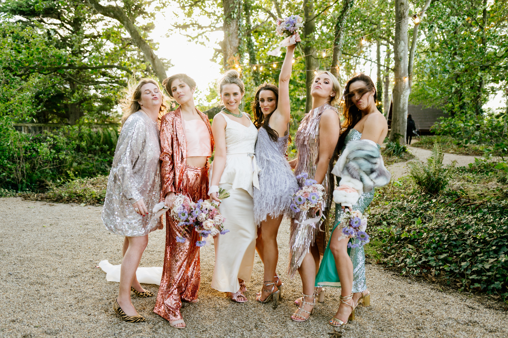 Bride and bridesmaids colourful dresses in forest park setting