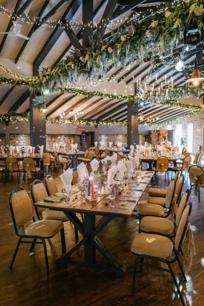 Empty dining room ballroom flowers candles and lights table chairs