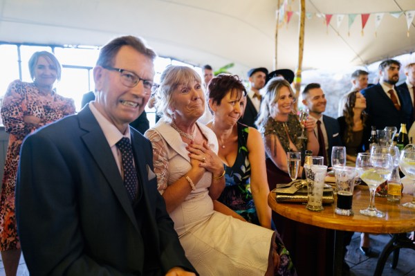 Womans hand on heard guests in audience