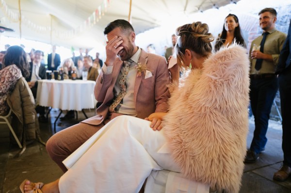 Embarrassed groom in suit and bride