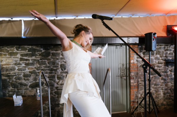 Bride beside microphone sings and gives speech