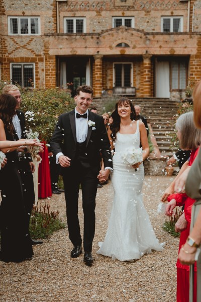 Confetti being thrown on couple bride and groom guests