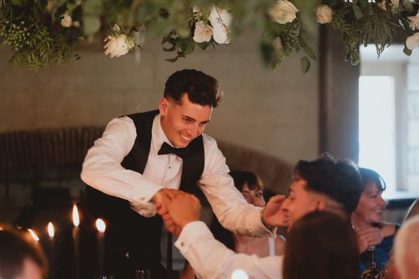 Groom in bowtie suit with groomsman