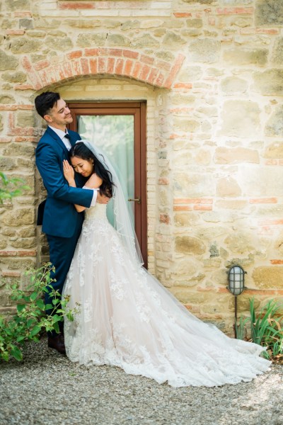 Bride hugs groom exterior shot