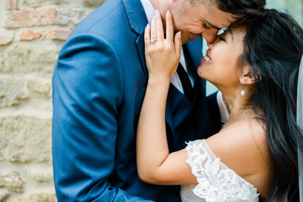 Bride and groom embrace hug and kiss