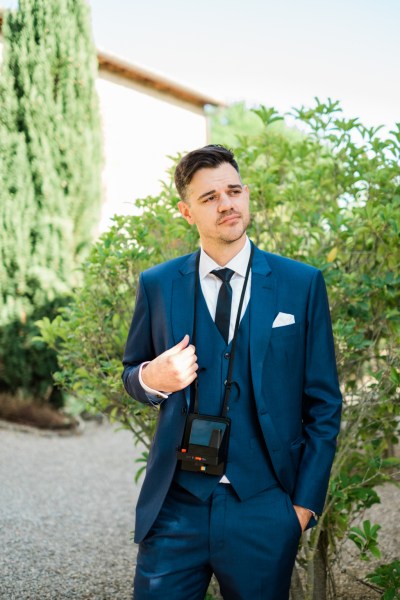 Groom in blue suit in garden