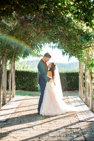 Rainbow camera effect over couple bride and groom hug