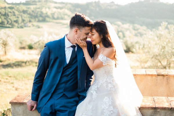 Bride and groom embracing hugging in front of scenic view