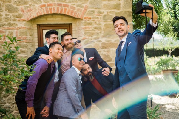 Groom taking selfie with groomsmen wearing sunglasses