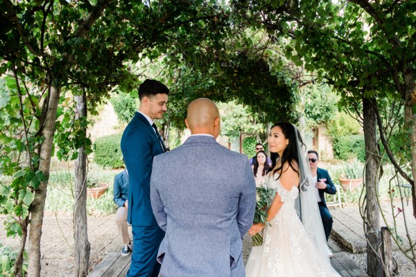 Bride groom and officiant at alter