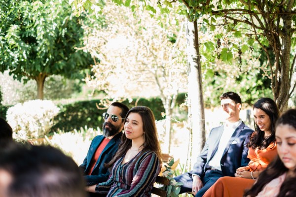 Audience members look at couple read vows