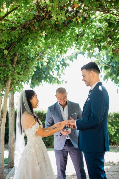 Bride groom and officiant during wedding ceremony