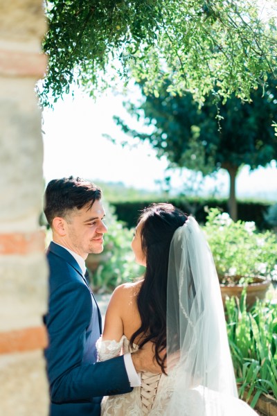 Bride and groom from behind veil detail in garden