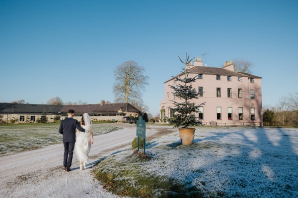 Bride and groom approach the wedding venue