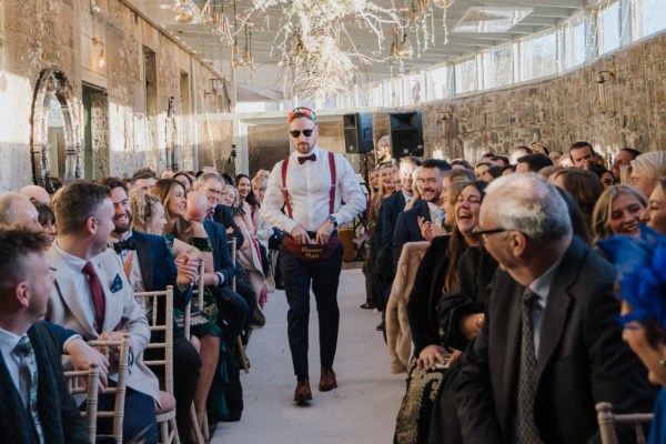 Groomsmen wearing sunglasses walks down the aisle