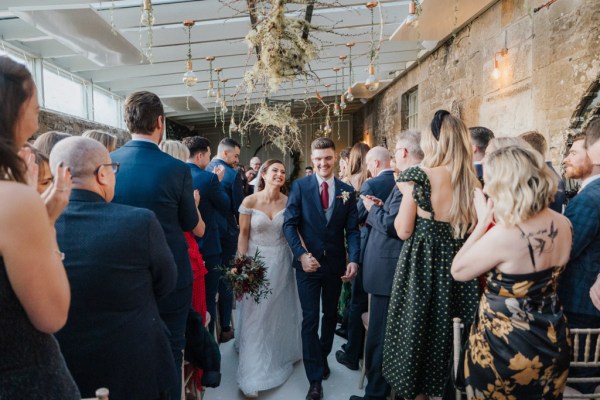 Bride and groom and guests clapping