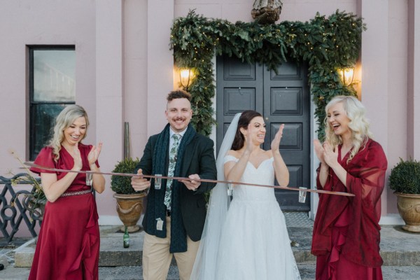 Bride and bridesmaids holding serving shots drinking