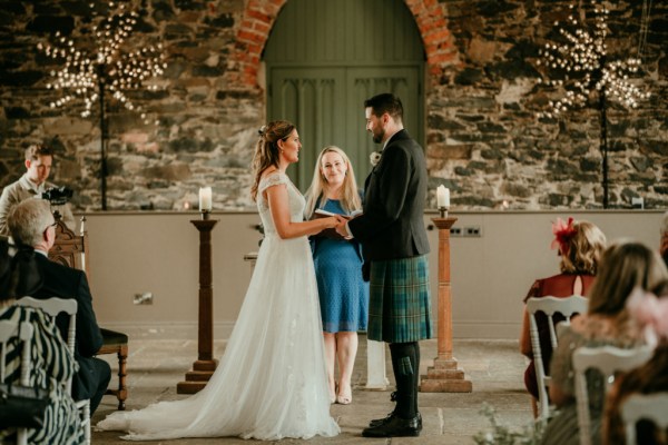 Bride and groom stand at the alter together with officiant/celebrant