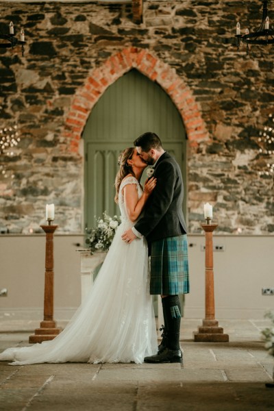 Bride and gorom kiss at the alter