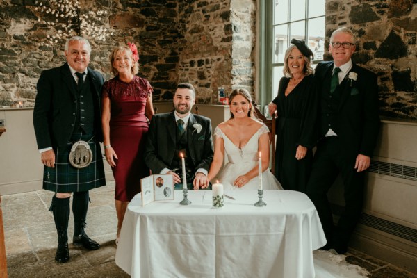 Bride mother father and groom at table witnesses