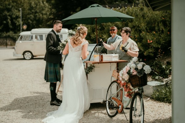 Bride and groom get ice cream at the truck