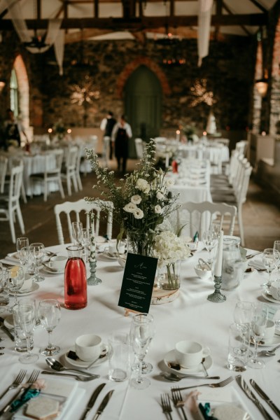 White roses flowers bouquet sitting on table dining room for guests