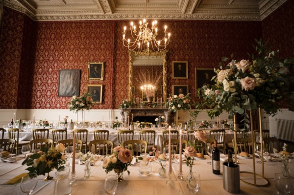 Empty dining room table chairs candles cutlery and flowers