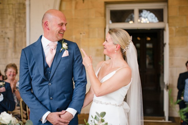 Bride groom smile during wedding ceremony