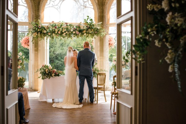 Bride and groom with celebrant at alter to ceremony