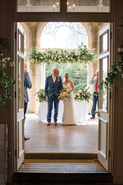 Bride and groom face guests as they are pronounced husband and wife