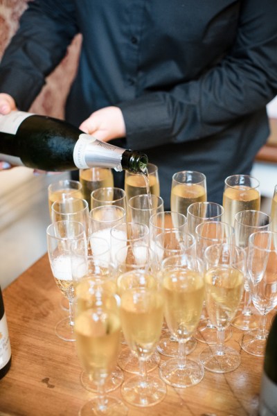 Waiter pouring champagne into glasses