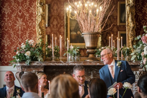 Father reading speech to couple and audience