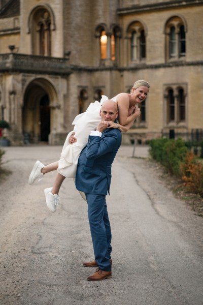 Groom picking up bride