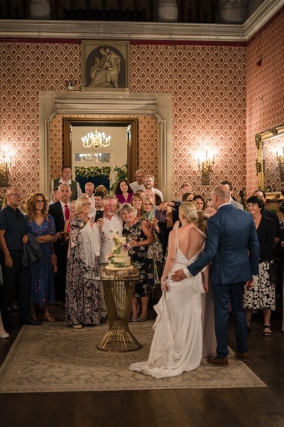 Bride and groom with guests interior manor house room