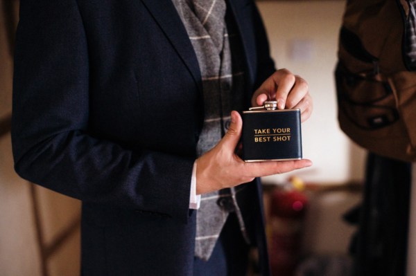 Groom holds Lock Lomond flask