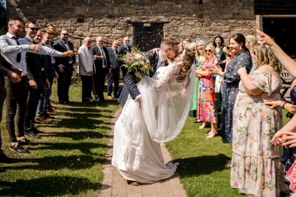 Bride and groom on pathway kissing kiss