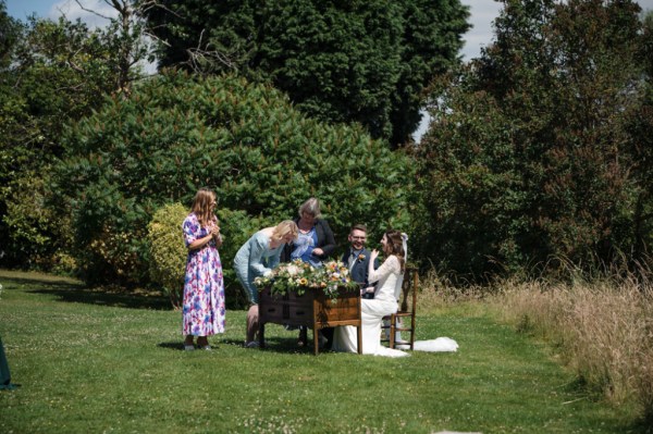 Bride and groom and family members witnesses to signing marriage wedding cert