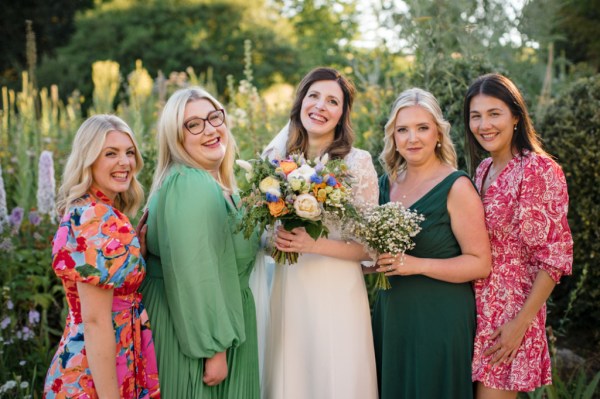 Smiling bride bridesmaids and friends