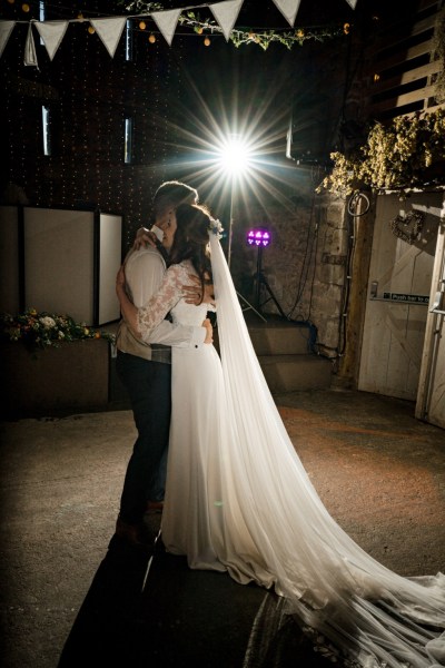 Bride and groom spotlight dancing on the dancefloor