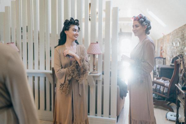 Bridesmaids with their hair being curled getting ready