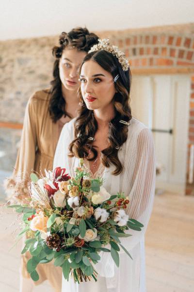 Bride and bridesmaid holding flowers