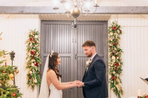 Bride and groom at alter holding each others hands