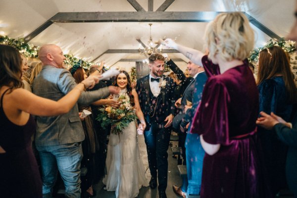 Bride and groom confetti guests exit ceremony flowers bouquet