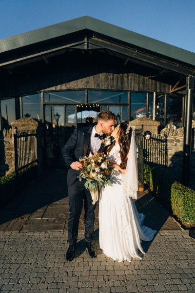 Bride and groom kiss kissing