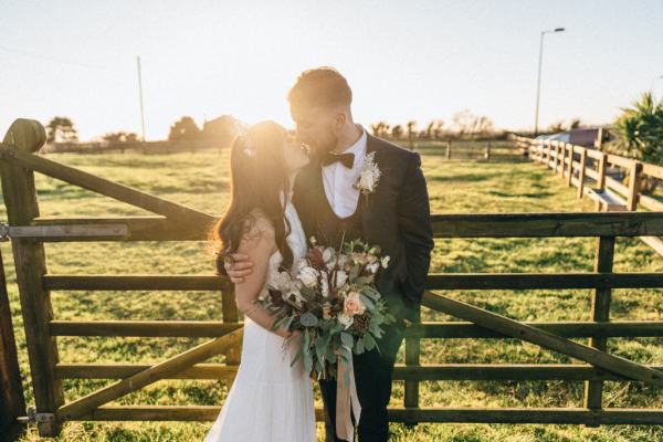 Sunset couple bride groom farm fence