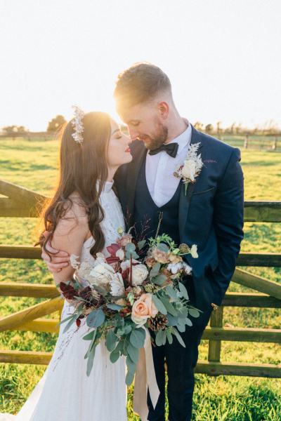 Sunset couple bride groom farm fence they look at each other