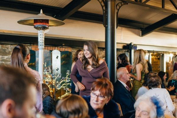 Atmosphere shot guests at table drinking talking