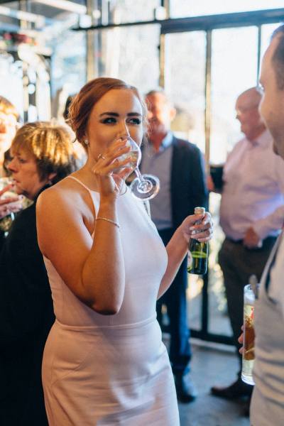 Atmosphere shot guests at table drinking talking