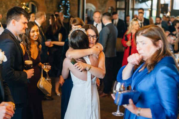 Guests with bride hugging and embracing