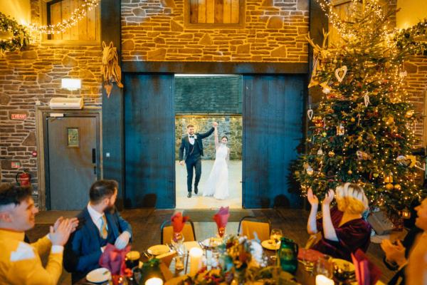 Bride and groom enter ballroom dining room guests clapping